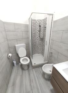 a bathroom with a shower and a toilet and a sink at Appartamento c&y via S Lorenzo in Novara +7 photos