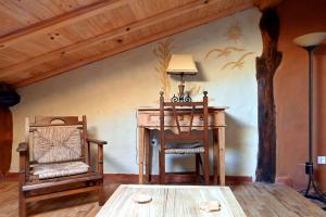 a room with a table and a chair and a desk at Casal da Serra in Penha Garcia
