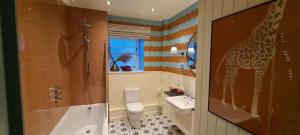 a bathroom with a giraffe painted on the wall at The Glenmorangie House in Tain +56 photos