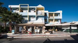 a large building with a restaurant in front of it at Minoa Hotel in Malia