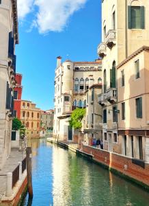 a canal in a city with buildings and water at Ca Savelli in Venice