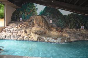 a large pool of water with a waterfall at Edgewater Hotel and Conference Center in Gatlinburg