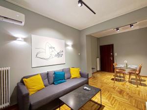 a living room with a couch and a table at Veno Apartments Goudi in Athens