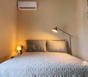 A bed or beds in a room at Athens Skylight Condo