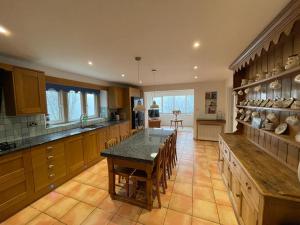 a large kitchen with a table and chairs in it at Lakeview Holidays in Whelford