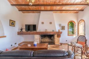 a living room with a couch and a fireplace at Es turo de ses illes in Ses Salines