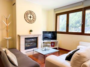 a living room with a couch and a fireplace at Apartamento moderno Pic negre con vistas in Mas de Ribafeta