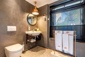 a bathroom with a toilet and a sink at Alacatı Port Ladera Hotel - Adult Only in Alaçatı +75 photos