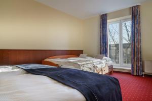 Postel nebo postele na pokoji v ubytování Hotel Hagemann Hamburg Hafen