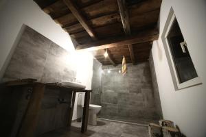 a bathroom with a sink and a toilet at Casa Padureana - Log House from 1860 in Hunedoara