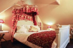 a bedroom with a bed with a canopy at Queenies, an authentic Rural Style coastal cottage in a Nature Reserve 