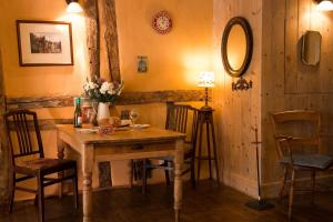 a room with a table with chairs and a mirror at The Old Monkey, a quirky bolthole on the edge of a historic Market Town in Hadleigh