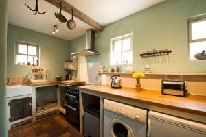 A kitchen or kitchenette at The Old Monkey, a quirky bolthole on the edge of a historic Market Town