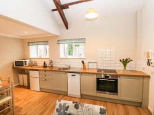a kitchen with a sink and a stove top oven at Dryslwyn Cottage in Carmarthen