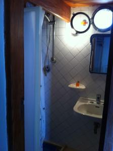 a bathroom with a sink and a mirror at Il Cubo, monovano col mare su tre fronti. in Favignana