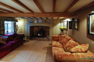 a living room with a couch and a fireplace at Laundry Cottage in a Nature Reserve - Sunday Times 100 coolest Cottages 