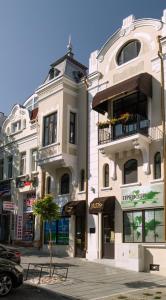 a large white building on a city street at MiTRa Luxury Apartments in Shumen