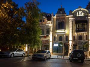 two cars parked in front of a building at MiTRa Luxury Apartments in Shumen