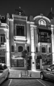 a black and white photo of a building with cars parked in front at MiTRa Luxury Apartments in Shumen