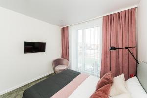 Un ou plusieurs lits dans un hébergement de l'établissement Cozy Piliamiesčio apartament by URBAN RENT