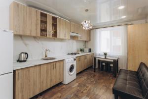 a kitchen with a sink and a washer and dryer at LUXE Apartments 5.26 near Lavina 5 floor in Sumy