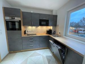 a kitchen with stainless steel appliances and a window at Hoger Ferienwohung in Lahr