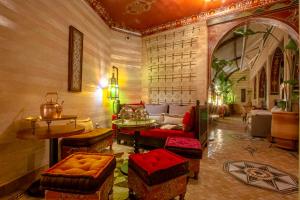 a living room with a couch and a table and chairs at Dar Anika in Marrakech