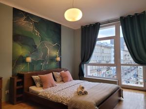 Łóżko lub łóżka w pokoju w obiekcie My Beloved Warsaw