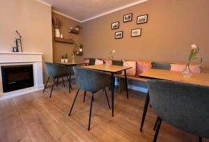 a living room with two tables and a couch at Pension Kitty in Pörtschach am Wörthersee +56 photos