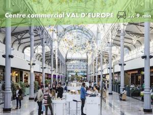a view of a shopping mall with people in it at Appartement de charme DISNEYLAND PARIS - Nidouest in Chanteloup-en-Brie