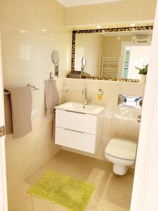y baño con lavabo, aseo y espejo. en Casa Sierra Marina, en Mijas Costa