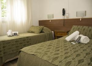 
a hotel room with two beds and a television at Hotel Montreal in Mar del Plata
