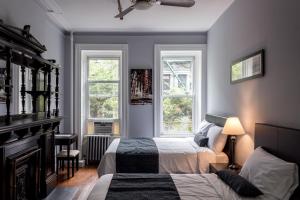 a bedroom with a bed and a window at The Central Park North in New York