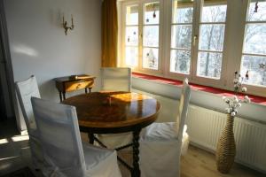 a dining room with a table and chairs and windows at Königliche Villa - Turmappartement in Berchtesgaden