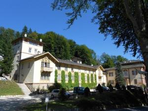 a large building with cars parked in front of it at Königliche Villa - Turmappartement in Berchtesgaden