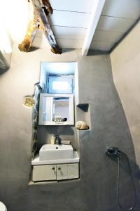 a bathroom with a sink and a mirror at Thomas Traditional House in Chora in Amorgos