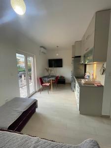 a room with a kitchen and a dining room at Cv apartment in Herceg-Novi