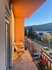 a balcony with a table and a view of a street at Cv apartment in Herceg-Novi