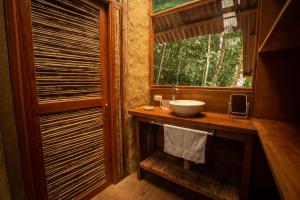 a bathroom with a sink and a window at Chirapa Manta Amazon Lodge in Lamas +86 photos