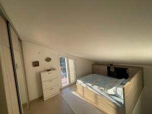 a small bedroom with a bed and a window at Cv apartment in Herceg-Novi
