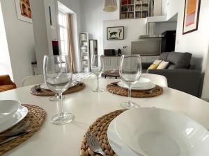 - une table avec des verres à vin et des assiettes dans l'établissement No 5 Cádiz, à Cadix