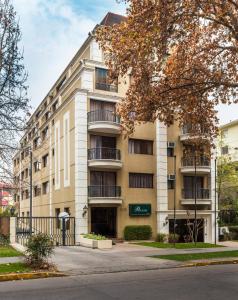 an apartment building with balconies on a street at Park Plaza Apartments in Santiago