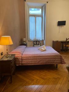 a bedroom with a bed and a lamp at Hotel Antica Dogana in Turin
