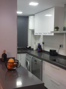 a kitchen with a bowl of oranges on a counter at NAUTILUS in Torrevieja +36 photos