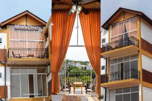 een uitzicht vanaf het balkon van een gebouw met een oranje gordijn bij WoodyCrest in Trincomalee