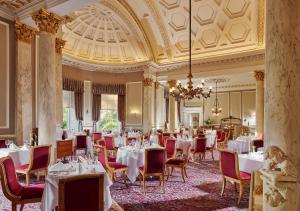a dining room with tables and chairs and a chandelier at Great Southern Killarney in Killarney