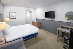a hotel room with a bed and a tv at Holiday Inn Hull Marina by IHG in Hull