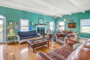 a living room with a couch and a table at Sweet Trade in Holden Beach