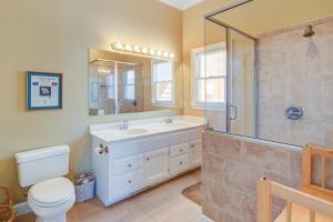 a bathroom with a shower and a sink and a toilet at Sweet Trade in Holden Beach +19 photos