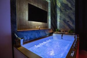 a large blue bath tub in a room at Pompei Luxury Rooms in Pompei